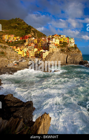 Swirling ocean at the foot of medieval town of Manarola in The Cinque Terre, Liguria Italy Stock Photo