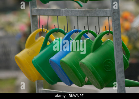 A line of colourful watering cans on the Isola di San Michele (St. Michael) cemetery island in Venice Stock Photo