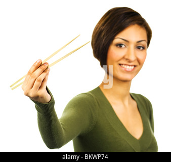 Young woman holds open a pair of chopsticks. Stock Photo