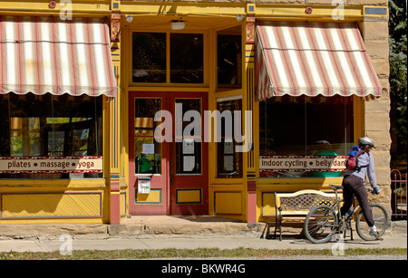 Stock photograph of  of bike rider in front of gym, Silverton, Colorado, USA. Stock Photo