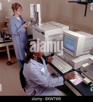 Female African American & Caucasian lab technicians testing water quality in the laboratory of a water utility company Stock Photo