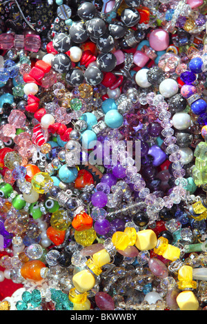 jewelry mixed colorful many jewels plastic jewelry background Stock Photo