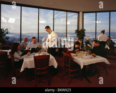 Waiters and customers dining in the 'Top of the 80's' restaurant, Hazleton, Pennsylvania, USA Stock Photo