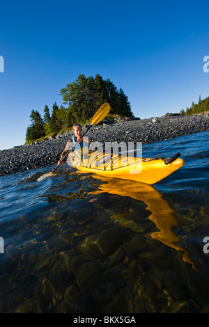 A man sea kayaking near the Porcupine Islands in Maine's Acadia National Park.  Frenchman Bay.  Bar Harbor. Rum Key. Stock Photo