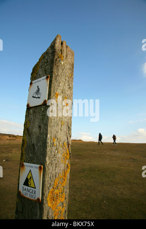 Cliff Edge warning sign on the South Downs Way near Beachy Head, South Downs, East Sussex, United Kingdom. Stock Photo