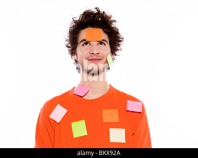 one young thinking with adhesive notes covering caucasian man portrait in studio on isolated white background Stock Photo