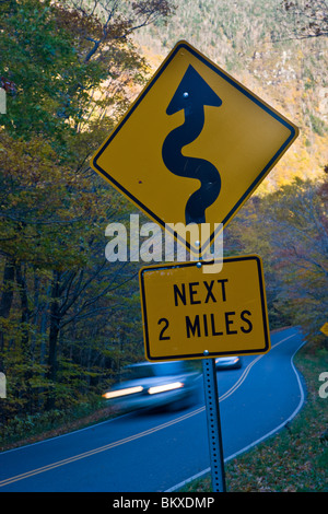 A narrow road (VT 108) winds its way through Smuggler's Notch near Stowe, Vermont.  Smuggler's Notch State Park. Fall. Stock Photo