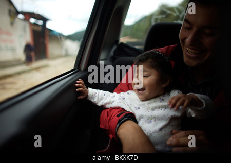 Alondra Viveros, who suffers from endoftalmitis, a fungus infection in the eye, in the arms of her father in Meson Viejo, Mexico Stock Photo