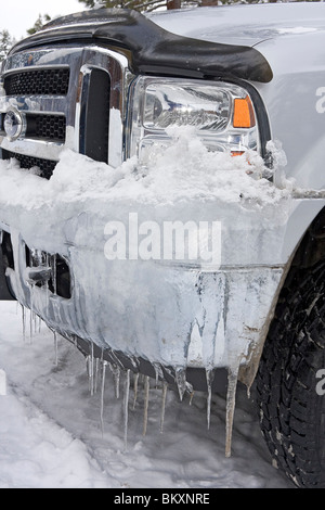Bumper of truck dripping with icicles during winter. USA Stock Photo