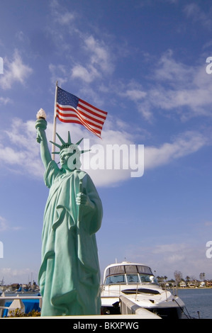 A replica of the Statue of Liberty is among the whimsical sculptures found on Balboa Island in Newport Harbor at Newport Beach in California, USA. Stock Photo