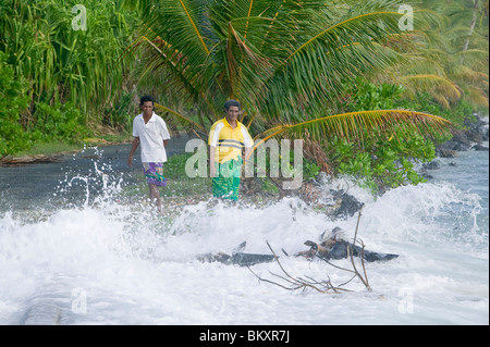 Tuvaluans watch as the high tide inundates their island home on funafuti due to global warming induced sea level rise Stock Photo