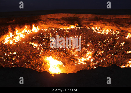 Derweze or Darvaza, aka the Door to Hell is a huge crater of burning natural gas in the Kara-kum desert in Turkmenistan. Stock Photo