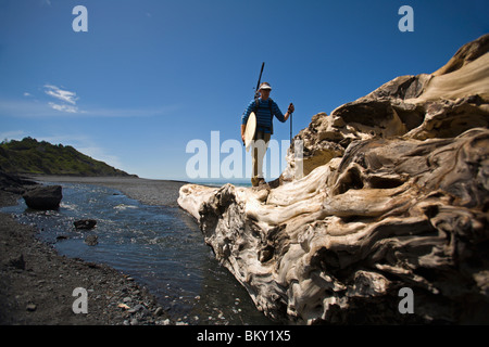 One man backpacks and surfs on The Lost Coast, California. Stock Photo