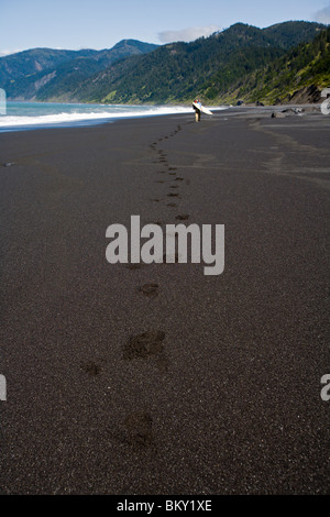 One man backpacks and surfs on The Lost Coast, California. Stock Photo