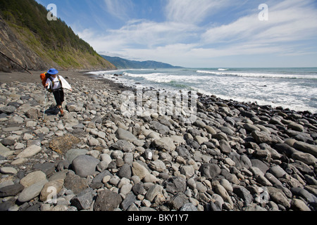 One man backpacks and surfs on The Lost Coast, California. Stock Photo