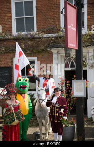 A group of characters assemble outside the White Horse Pub in the High Street on St George's day, Haslemere, Surrey, England. Stock Photo