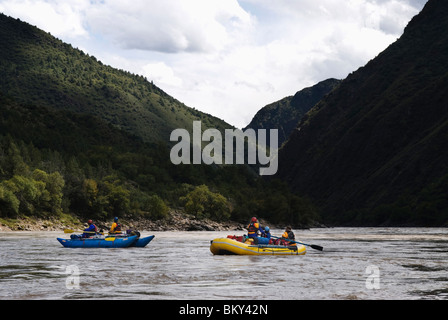Rubber rafts row downstream during a whitewater rafting trip in Western ...