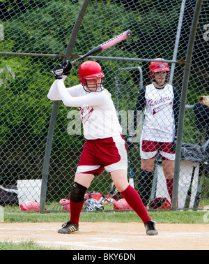 A high school girls softball game. A batter at bat at home plate. Stock Photo