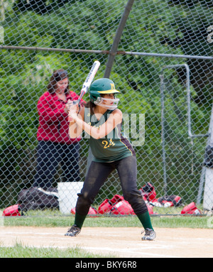 A high school girls softball game. A batter at bat at home plate. Stock Photo