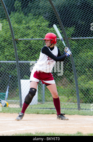 A high school girls softball game. A batter at bat at home plate. Stock Photo