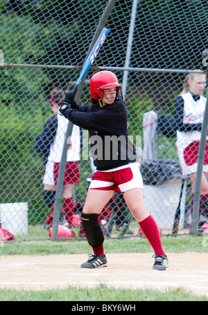 A high school girls softball game. A batter at bat at home plate. Stock Photo