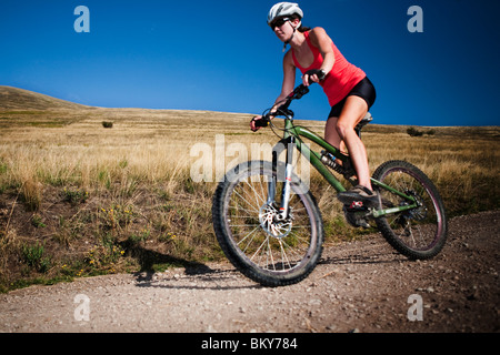 A female mountain biker pedals the trail on Mt. Sentinel, Missoula, Montana. Stock Photo