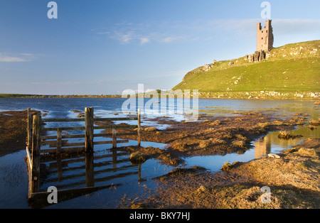 Dunstanburgh Castle in early evening sunlight Stock Photo