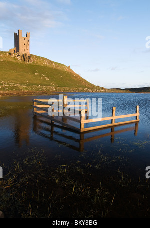 Dunstanburgh Castle in early evening sunlight Stock Photo