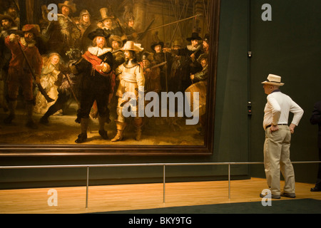 Visitor, Rembrandt, The Nightwatch, Rijksmuseum, Man looking at The Nightwatch, a painting by Rembrandt van Rijn, Rijksmuseum, A Stock Photo