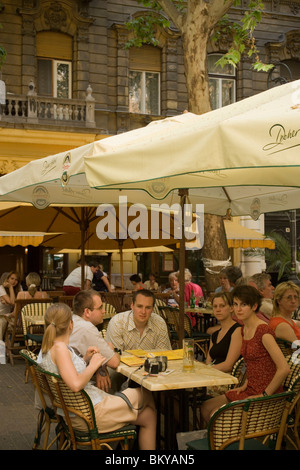 People in open-air cafe, Young people sitting in an open-air Cafe at Liszt Square, Pest, Budapest, Hungary Stock Photo