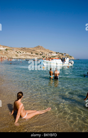 View over peopled Paradise Beach, Boat arriving, taking tourits to the beach, Mykonos, Greece Stock Photo