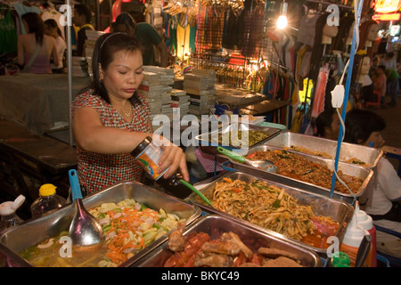 Woman preparing fresh food at a  stand at Th Khao San Road in the evening, Banglamphu, Bangkok, Thailand Stock Photo