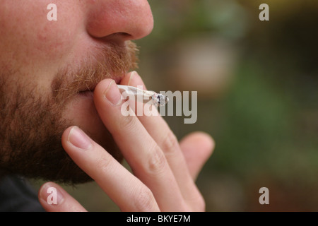 Detail of a smoker inhaling Stock Photo