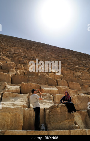 Tourist couple using camera while sightseeing at the Great Pyramids of Giza, Cairo, Egypt Stock Photo