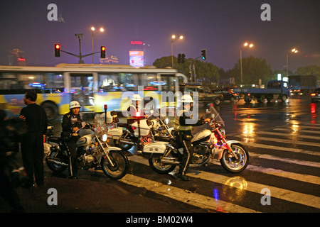 Traffic Shanghai, motorbike patrol, Polizei, police, Bund, junction, Nanjing Road, Blaulicht, rain Stock Photo