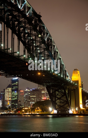 Sydney Harbour Bridge lit up at night, with the city of Sydney in the background. Stock Photo