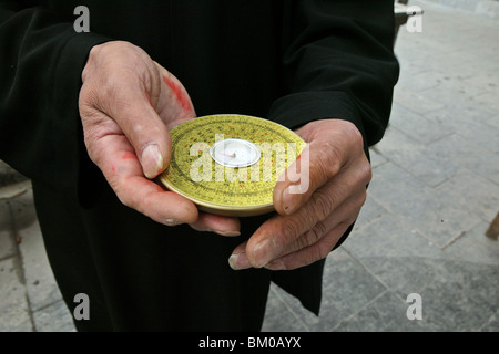 Chinese Feng Shui compass, a Lopan, in hands of Fengshui master, China, Asia Stock Photo