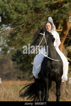 angel and friesian horse Stock Photo