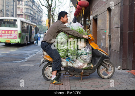 Man transporting vegetables on a scooter, Fuzhou Road, Shanghai, China, Asia Stock Photo