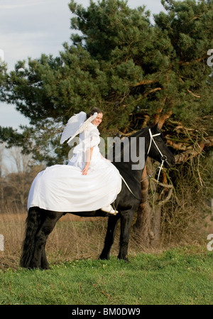 angel and friesian horse Stock Photo