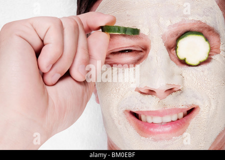 Cucumber slices on a man's eyes Stock Photo