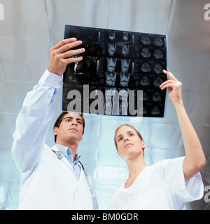 Doctor and a female nurse examining an x-ray report Stock Photo