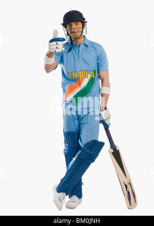 Cricket batsman standing at the non striker end and showing thumbs up sign Stock Photo