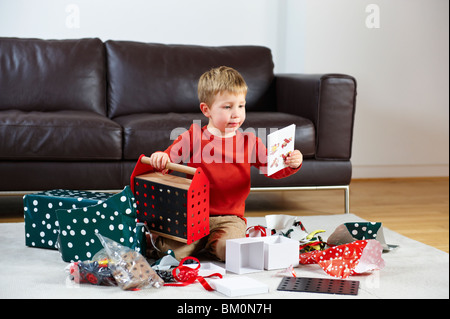 Young boy opening presents Stock Photo
