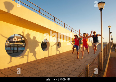 Happy young people leaping Stock Photo