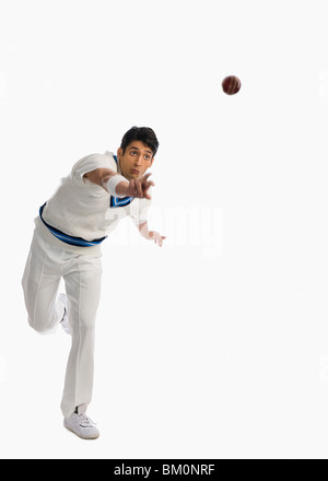 Cricket bowler in action Stock Photo