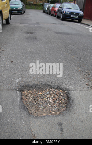 Pot hole marked for repair in a suburban road in Hounslow, Middx, UK. May 2010. See BM0PWD  & BM0Y0Y for repaired view. Stock Photo