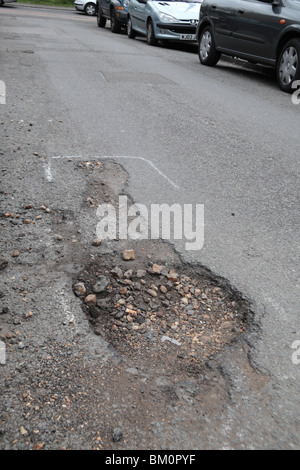 Pot holes marked for repair in a suburban road in Hounslow, Middx, UK. May 2010.  See BM0Y2M  for repaired view. Stock Photo