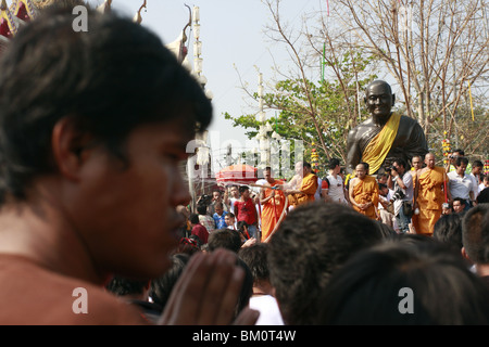 Man in prayer during Wai Kru Day at Wat Bang Phra, a Buddhist temple in Thailand where monks tattoo devotees. Stock Photo