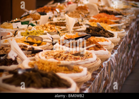 dried nuts, fruits and organic whole foods in bowls at French market Stock Photo